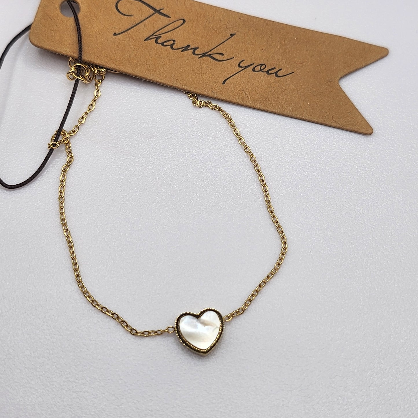 Pulseira com Coração de madrepérola dourada em Aço Inox