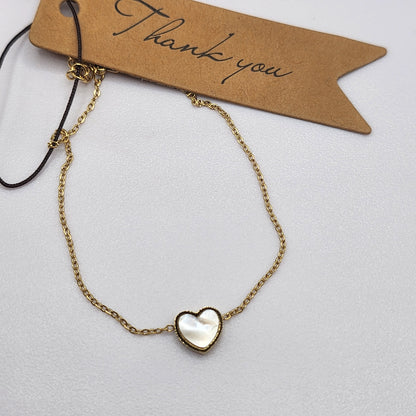 Pulseira com Coração de madrepérola dourada em Aço Inox